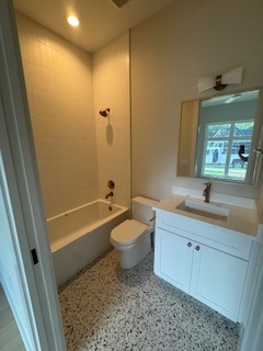 Full bathroom with tub-shower combo and terrazzo-style tile Full bathroom with tub-shower combo and terrazzo-style tile